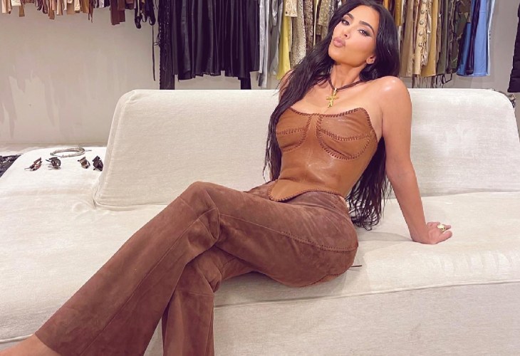 Kim Kardashian poses on sofa