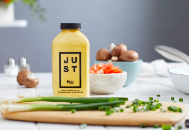 JUST egg bottle next to a chopping board and vegetables