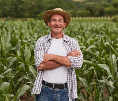 A farmer stands in a field of crops