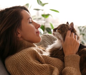 A woman and a cat looking at each other