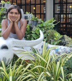 Mitali Deypurkaystha smiling on a cow statue