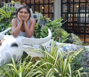 Mitali Deypurkaystha smiling on a cow statue