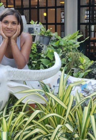 Mitali Deypurkaystha smiling on a cow statue