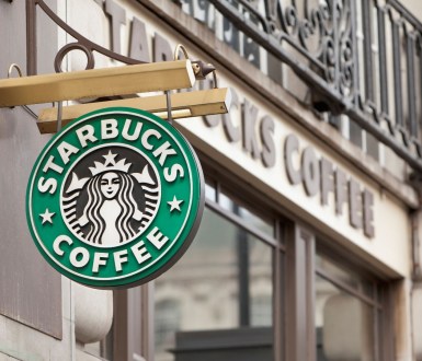 Starbucks sign hanging from a store front in London