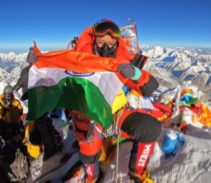 Prakriti Varshney holds the Indian flag at the top of Everest