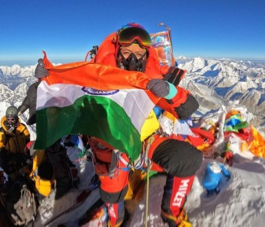 Prakriti Varshney holds the Indian flag at the top of Everest