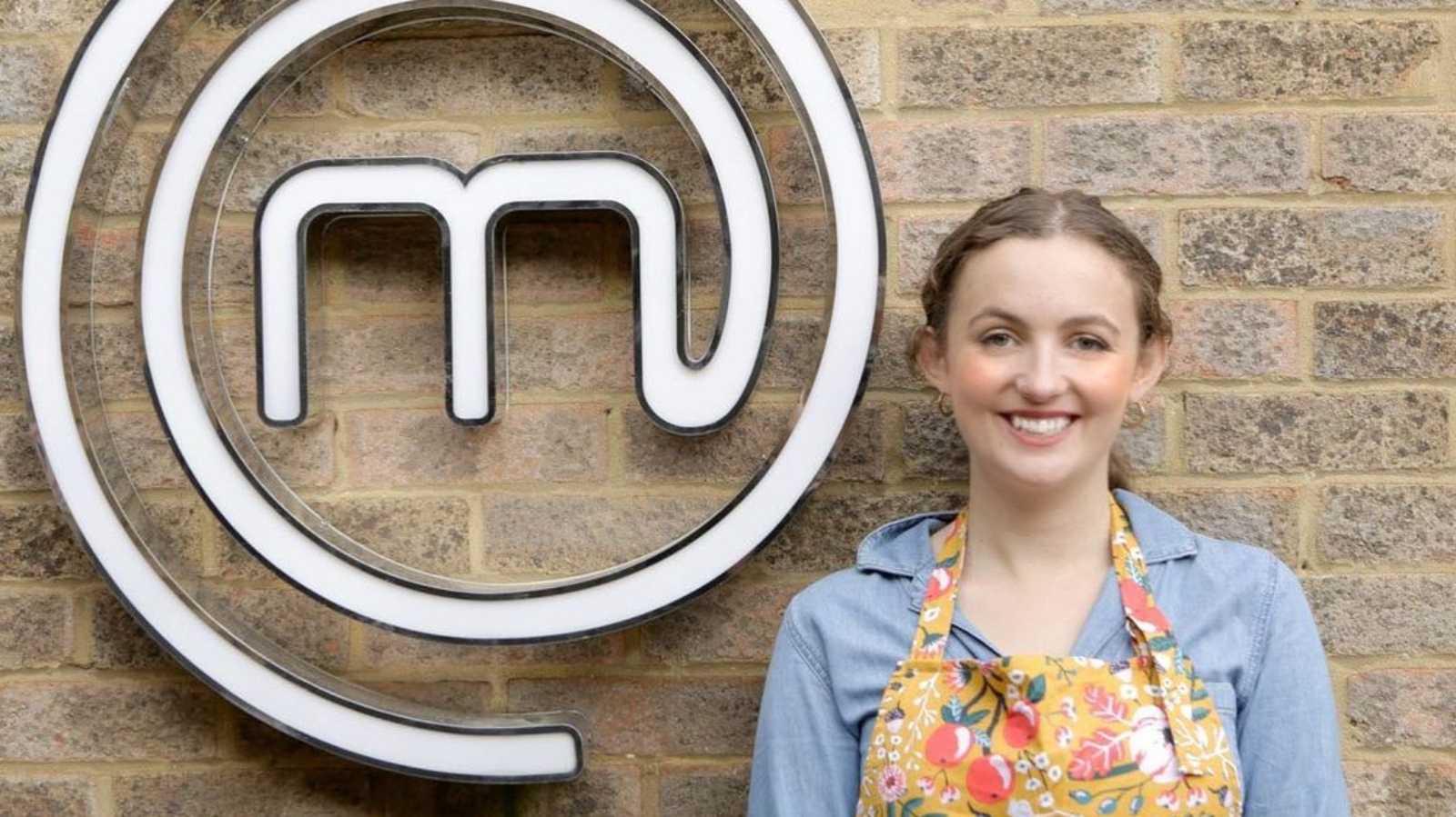 Vegan chef Meg Long smiling next to the MasterChef logo