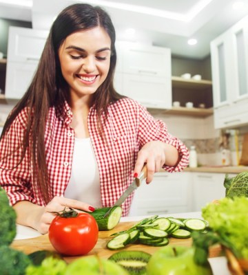 Woman cutting vegetables in the kitchen