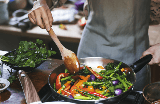 A person cooking vegetables